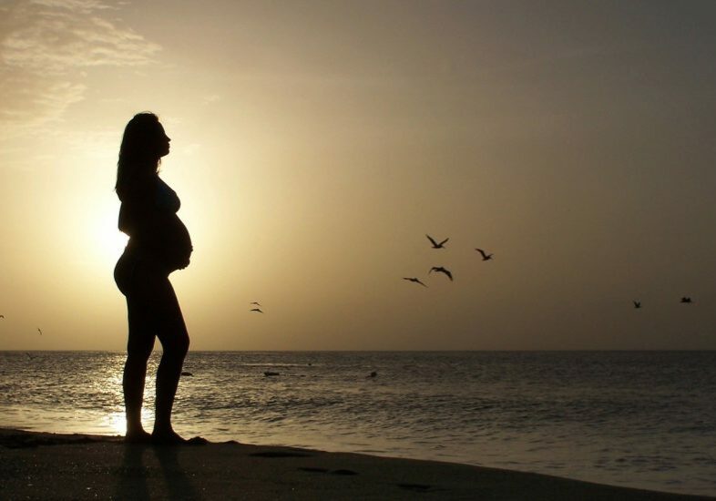Pregnant woman on beach